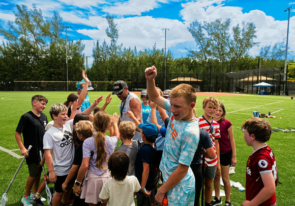 Young athletes and coach celebrating on the field